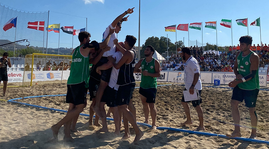 Mehdi Ghashghaeirad is thrown up and down by his players after Iran won bronze