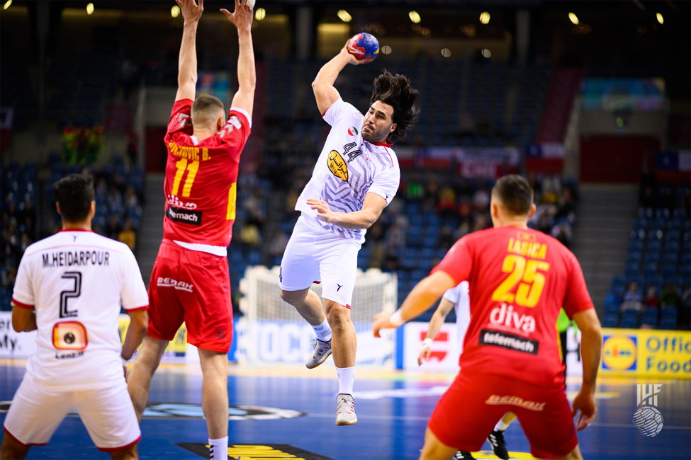 Iran player shooting in front of the block