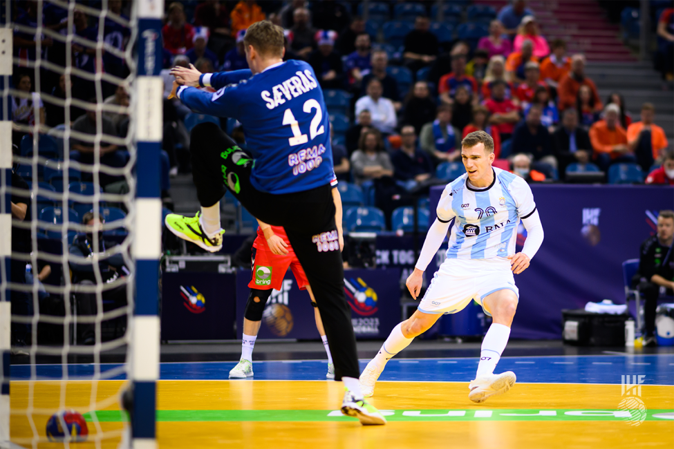 Argentina player shooting and Norway goalkeeper trying to block