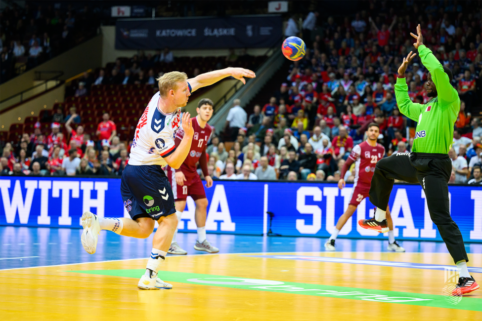 Norway player shooting with Qatari goalkeeper trying to save the shot