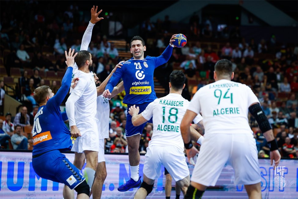 Serbia player shooting in front of the defencive block